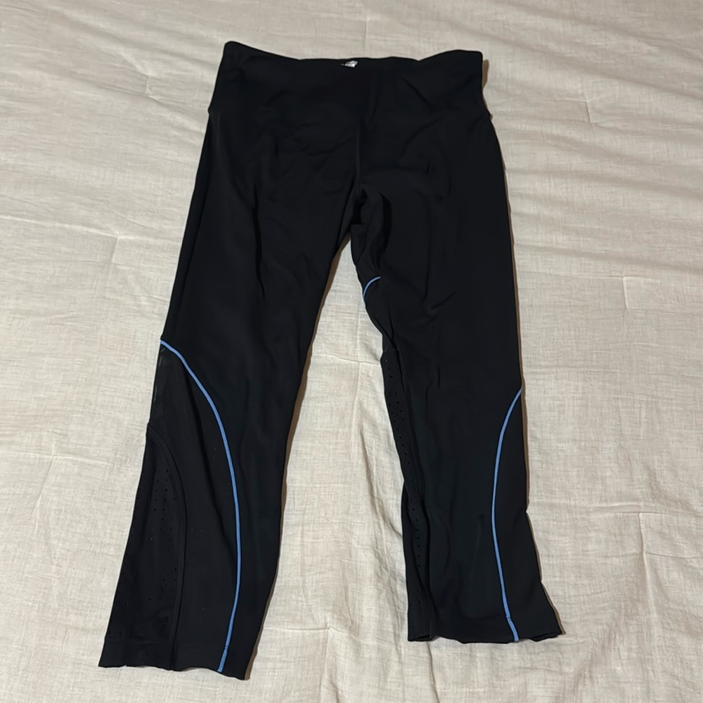 Long, black, stretchy, leggings. Size large, color black with blue stripe.